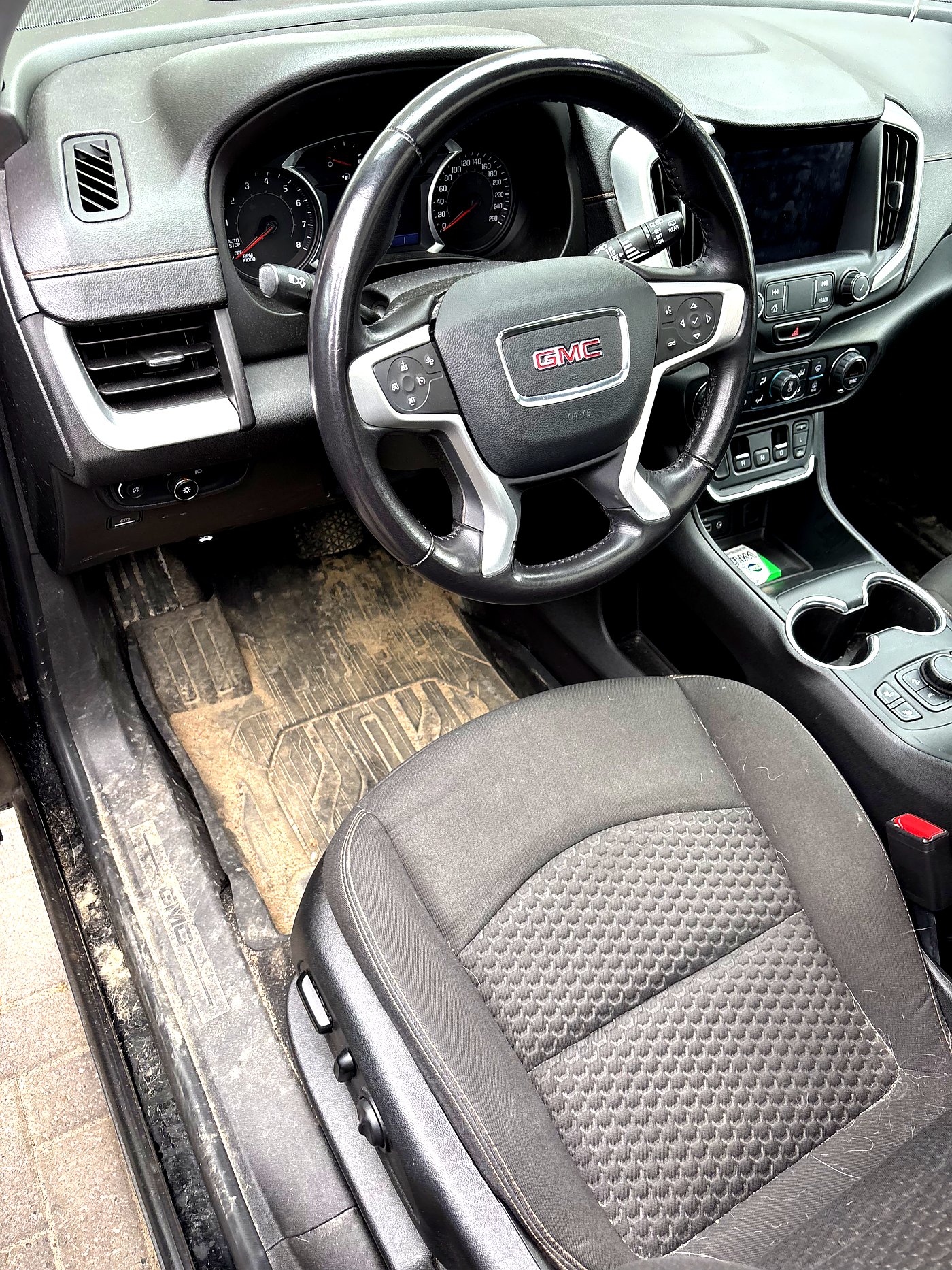 Before GMC interior detailing North Bay — dirty floor mats and seat