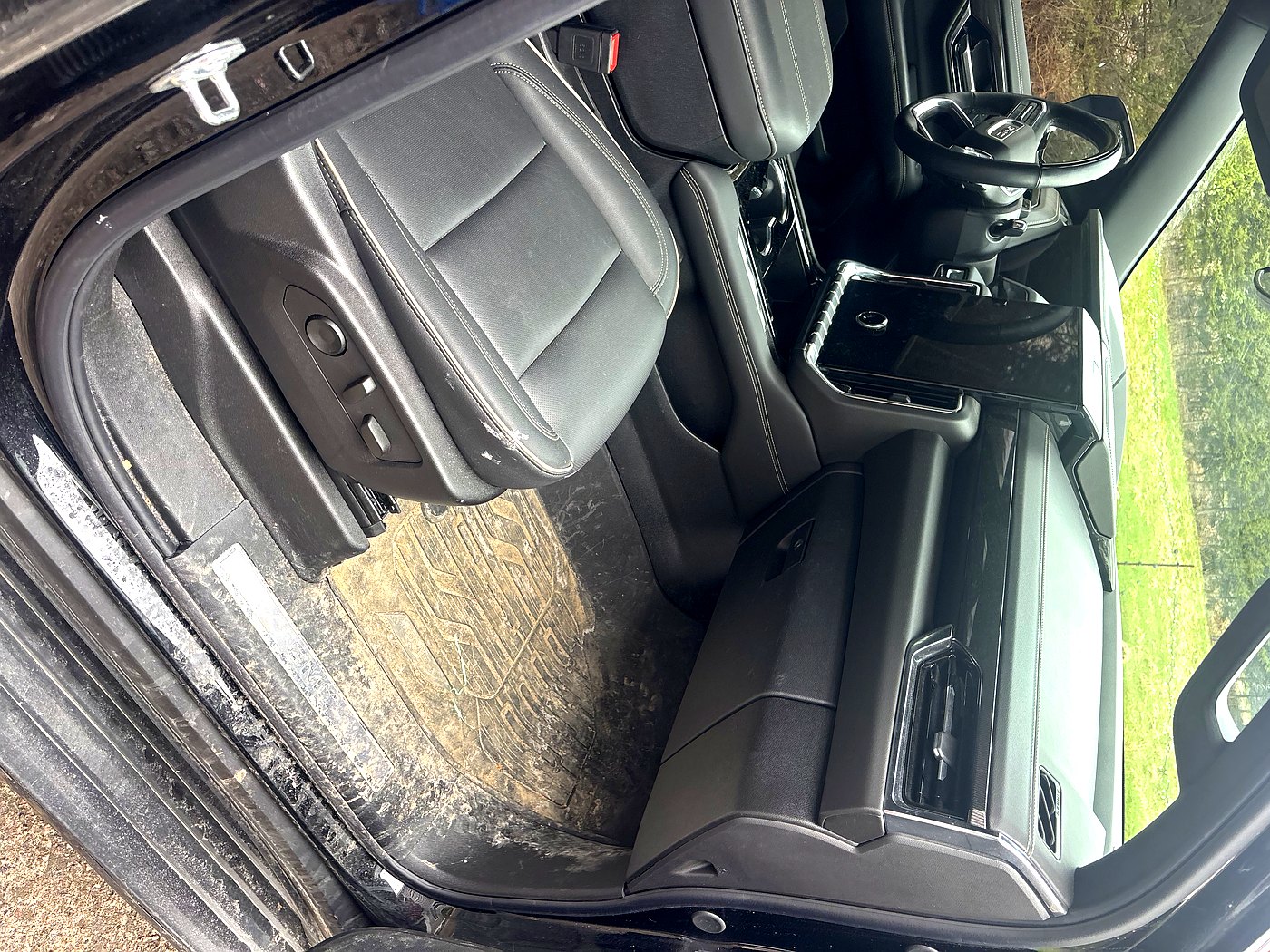 Before GMC Sierra interior detail North Bay — salt and mud on floor mat