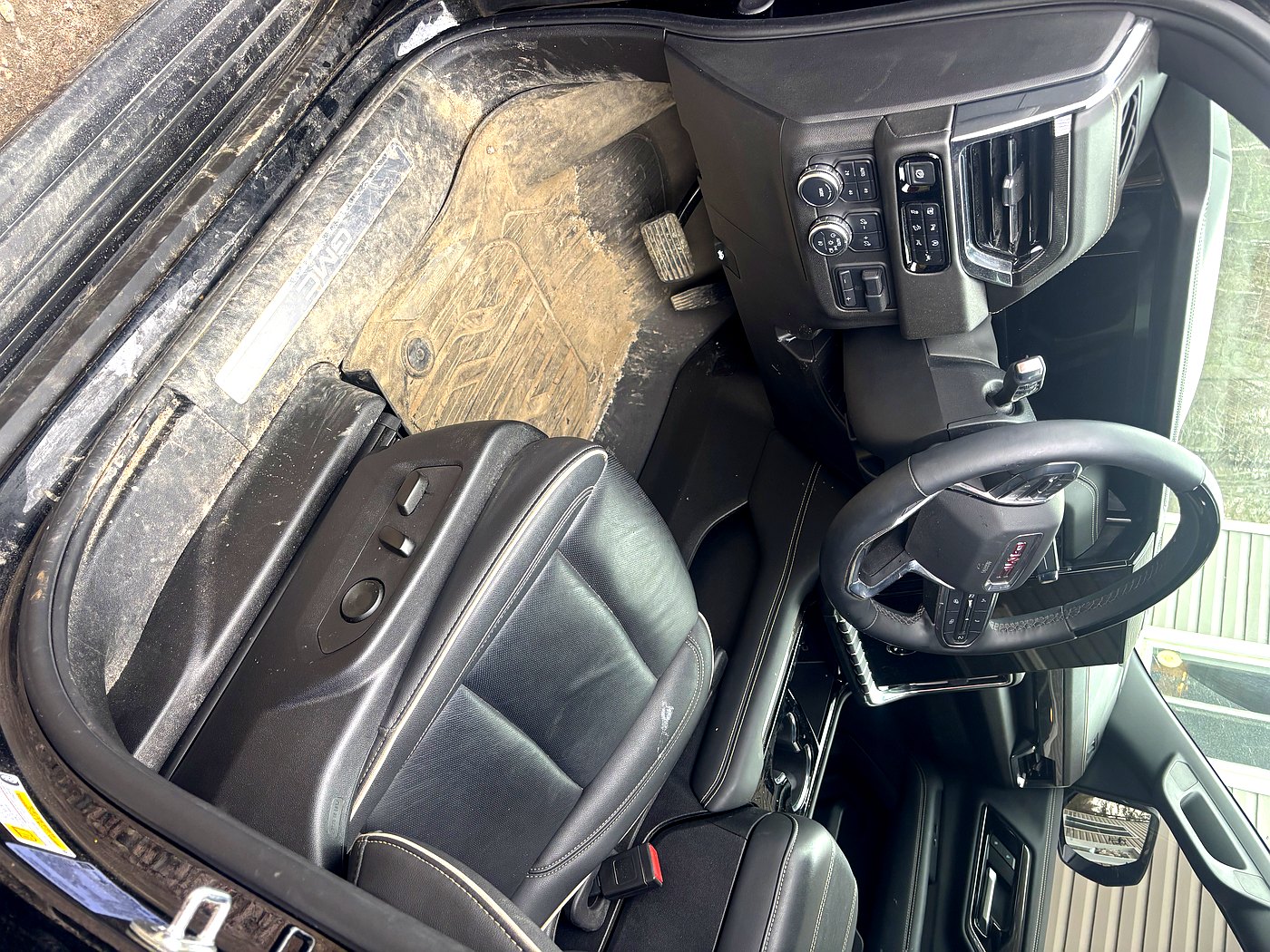 Before GMC Sierra interior detail North Bay — filthy driver floor mat and seat